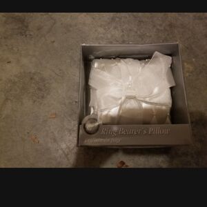 Ring bearer pillow and flower girl basket with white rise pedals.